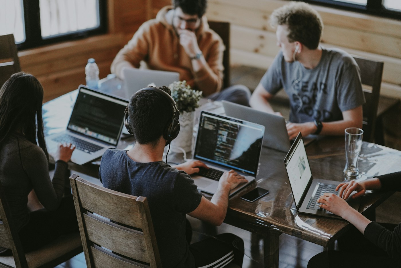 A software team collaborating around a laptop